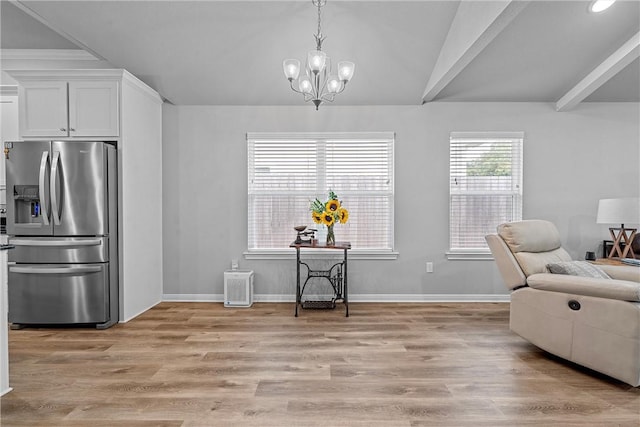 interior space with lofted ceiling with beams, a chandelier, and light wood-type flooring