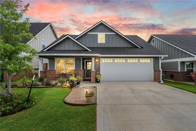 craftsman house featuring a yard and a garage