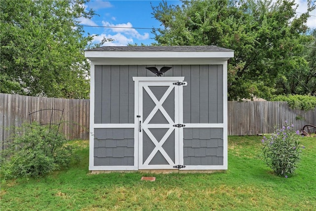 view of outbuilding with a lawn