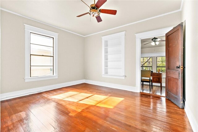 bathroom featuring tile patterned floors, vanity, crown molding, a bath, and toilet