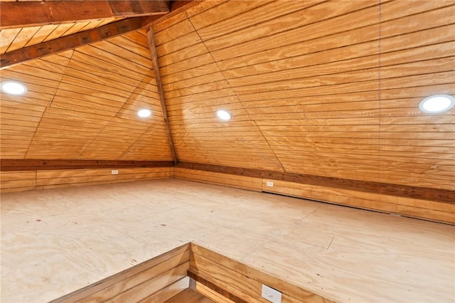 additional living space featuring wood ceiling, lofted ceiling, and wooden walls