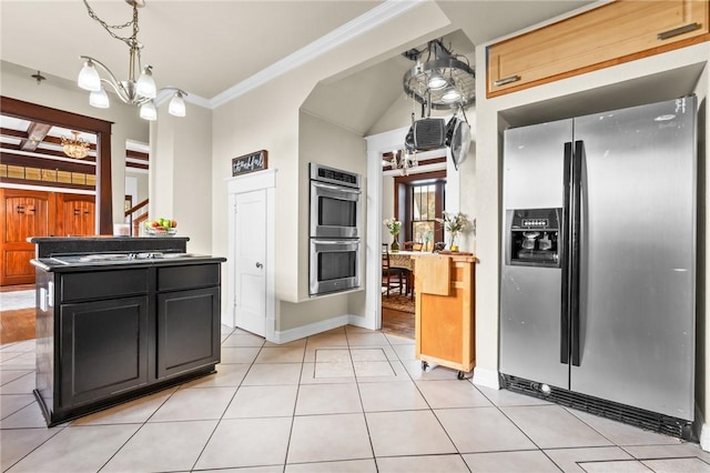 kitchen with ornamental molding, stainless steel appliances, light tile patterned floors, pendant lighting, and an inviting chandelier