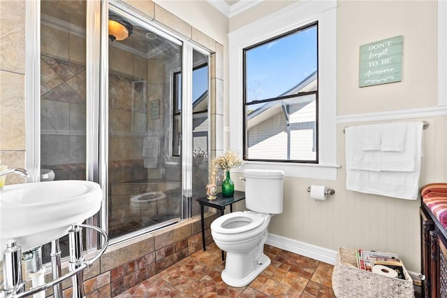 bathroom with toilet and an enclosed shower