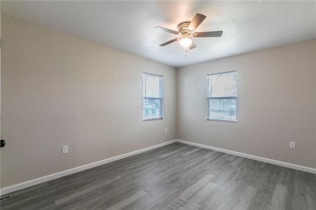 unfurnished room featuring ceiling fan and dark hardwood / wood-style flooring