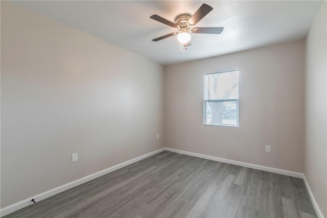 spare room featuring hardwood / wood-style floors and ceiling fan