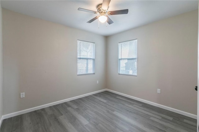 unfurnished room with dark wood-type flooring and ceiling fan