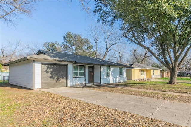 ranch-style home with a garage and a front lawn