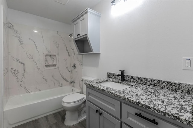 full bathroom featuring vanity, toilet, hardwood / wood-style floors, and tiled shower / bath