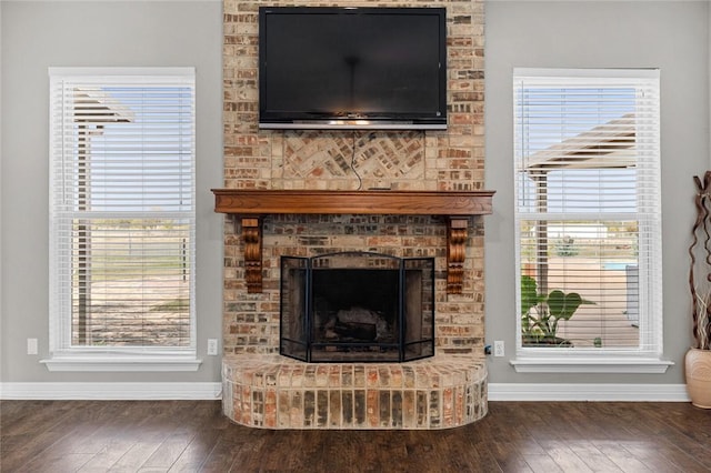 living room with dark hardwood / wood-style floors and a fireplace