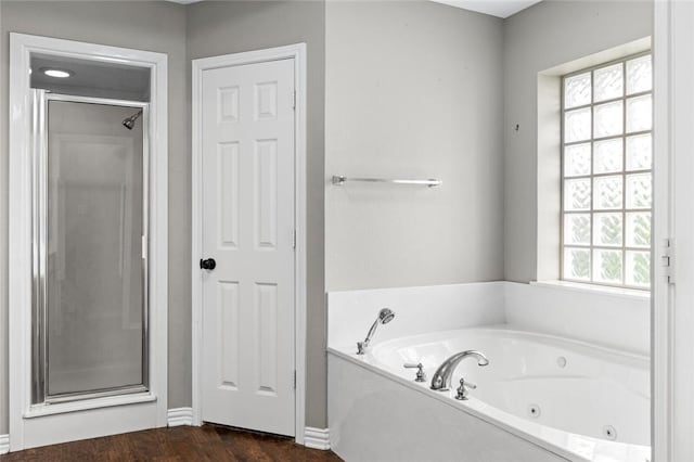 bathroom with wood-type flooring, separate shower and tub, and a healthy amount of sunlight