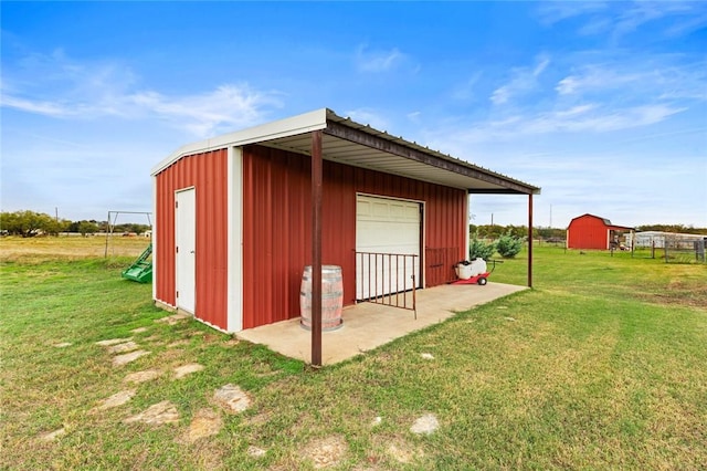 view of outdoor structure with a garage and a yard