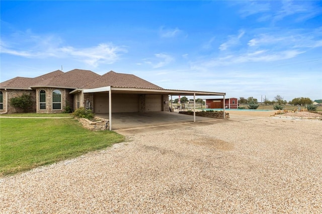 view of front of house featuring a front lawn and a carport