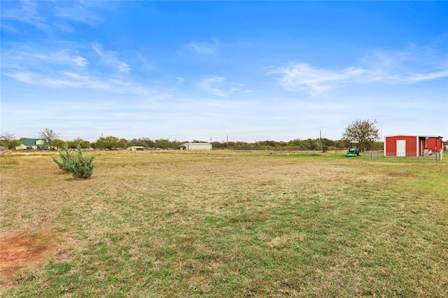 view of yard with a rural view