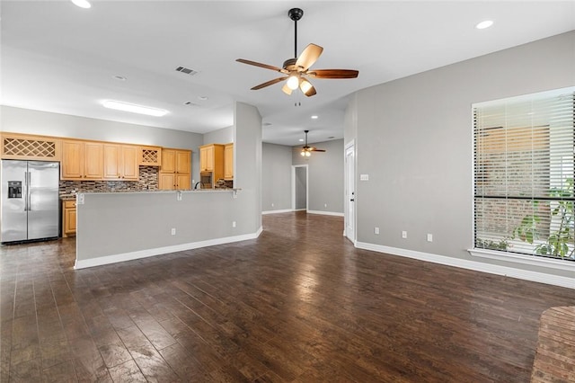 unfurnished living room featuring dark hardwood / wood-style flooring and ceiling fan