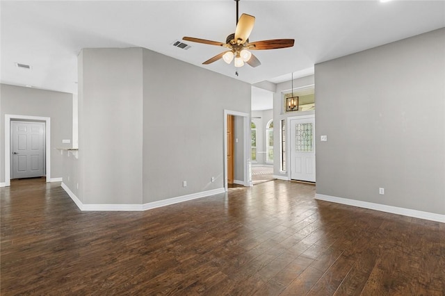 unfurnished room featuring dark hardwood / wood-style flooring and ceiling fan with notable chandelier