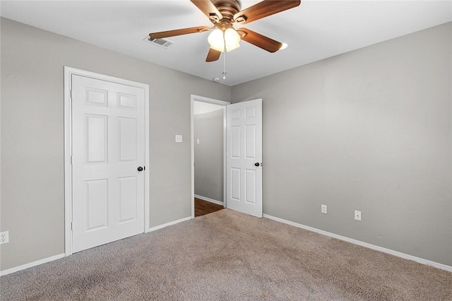 unfurnished bedroom featuring ceiling fan and carpet floors