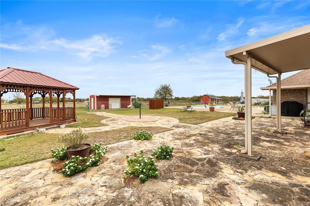 view of yard with a gazebo and a storage unit