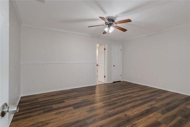 empty room featuring dark hardwood / wood-style floors, ceiling fan, and crown molding