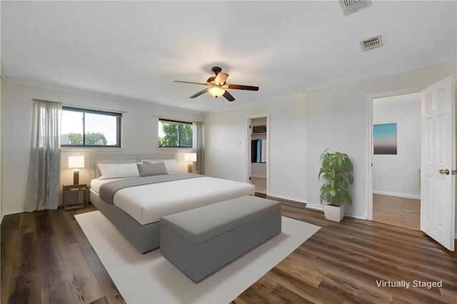 bedroom featuring crown molding, ceiling fan, and dark wood-type flooring