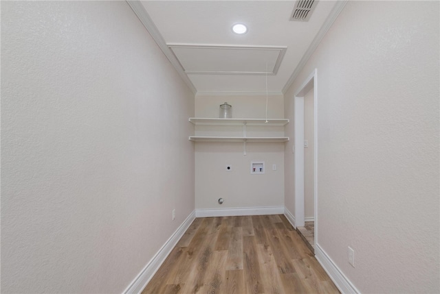 laundry area with hookup for a washing machine, ornamental molding, light wood-type flooring, and hookup for an electric dryer