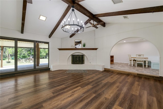 unfurnished living room with vaulted ceiling with beams, dark wood-type flooring, a chandelier, and a brick fireplace