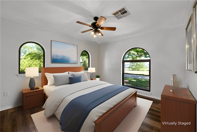 bedroom with ceiling fan, dark hardwood / wood-style flooring, crown molding, and multiple windows