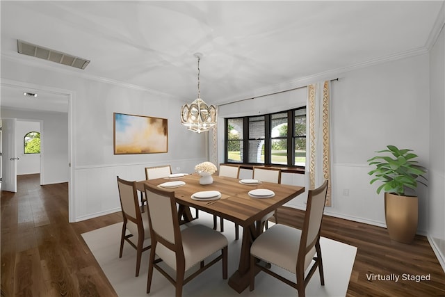 dining area with a wealth of natural light, an inviting chandelier, dark hardwood / wood-style floors, and ornamental molding