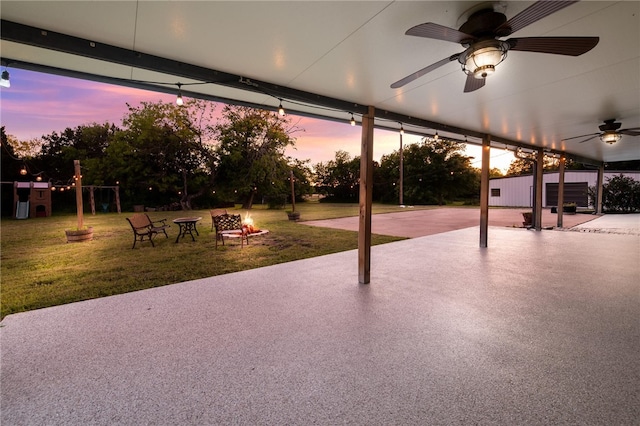 patio terrace at dusk featuring ceiling fan