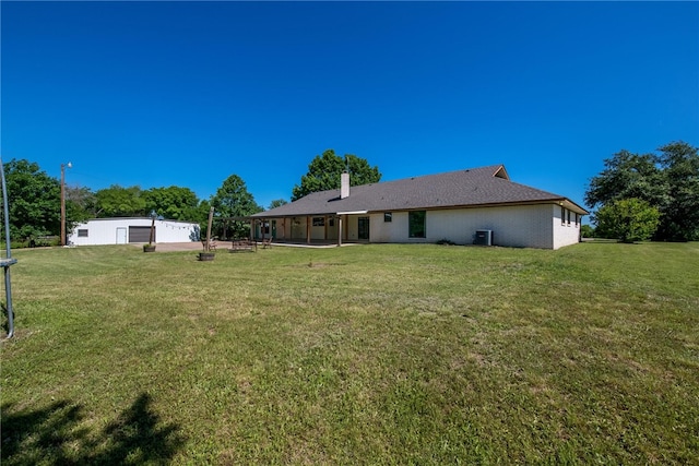 exterior space with a lawn and central AC unit