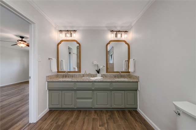 bathroom with wood-type flooring, ceiling fan, and ornamental molding