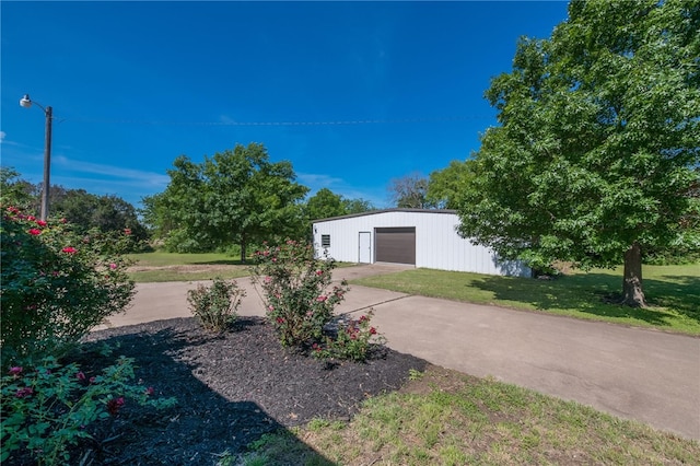 exterior space featuring a garage and an outbuilding