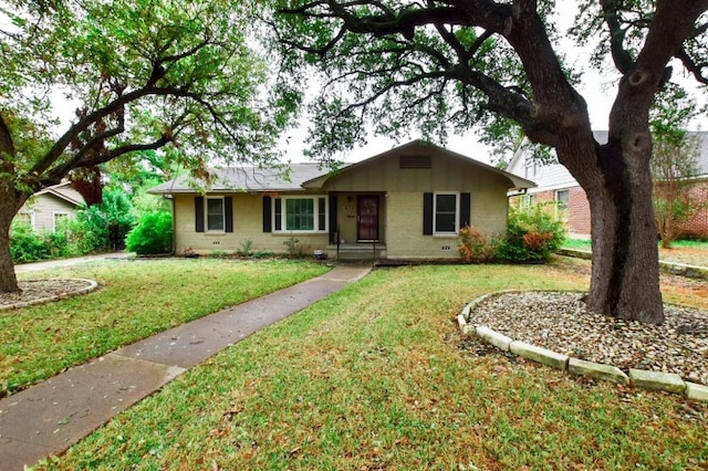 single story home featuring brick siding and a front yard