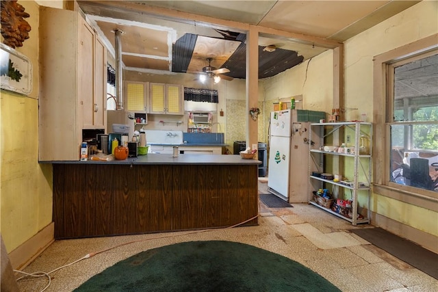 kitchen featuring ceiling fan, white refrigerator, and kitchen peninsula