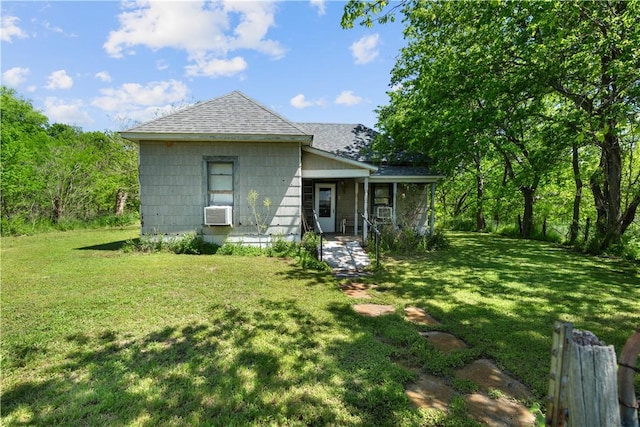 back of property featuring a lawn