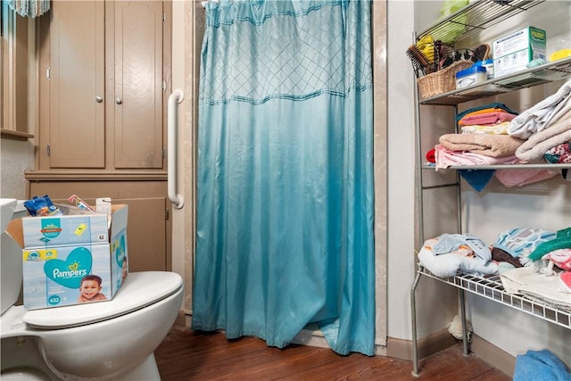 bathroom featuring hardwood / wood-style flooring and toilet