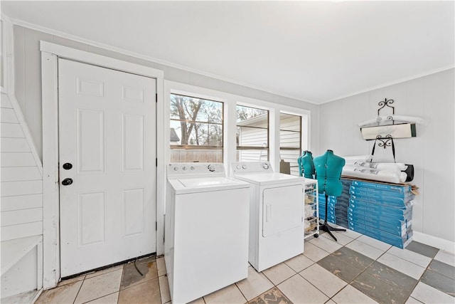 clothes washing area featuring separate washer and dryer and crown molding