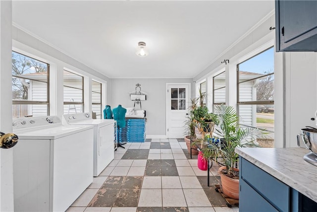 laundry area with crown molding, cabinets, and washing machine and clothes dryer