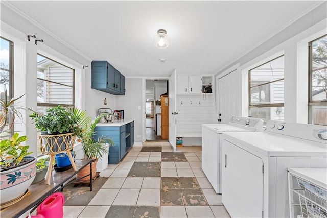 laundry area featuring plenty of natural light, ornamental molding, and washing machine and clothes dryer