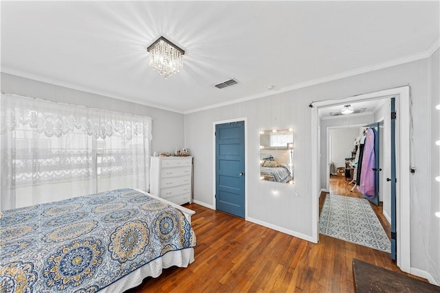 bedroom with crown molding and dark hardwood / wood-style floors