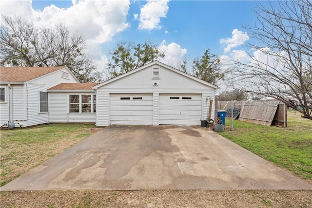 exterior space with a garage and a front lawn