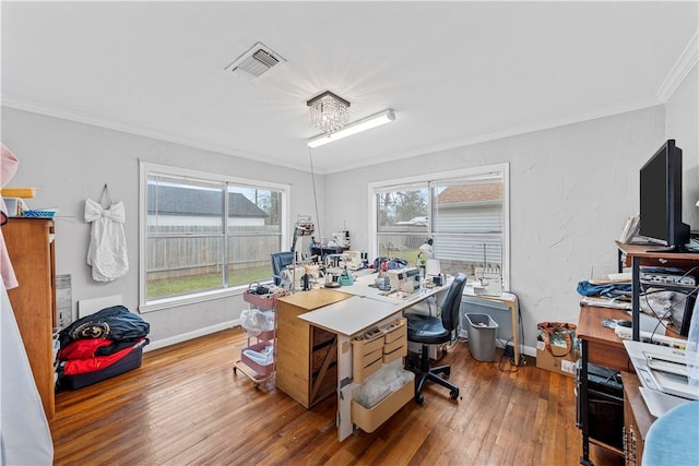 office space with hardwood / wood-style floors and crown molding