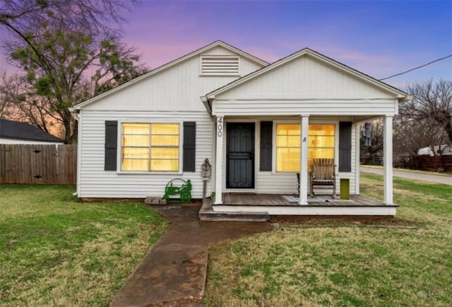 view of front of home with a yard and covered porch