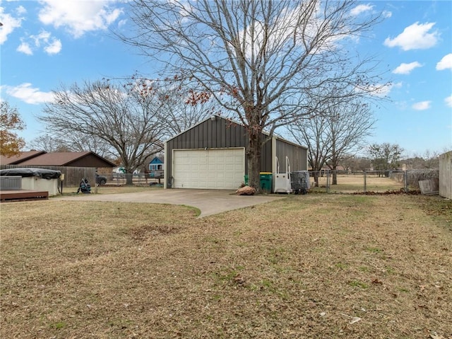 view of home's exterior featuring a garage, a yard, and an outbuilding