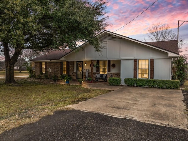 ranch-style home featuring a porch and a yard