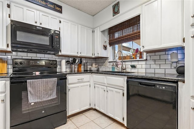 kitchen with black appliances, decorative backsplash, sink, light tile patterned flooring, and white cabinetry