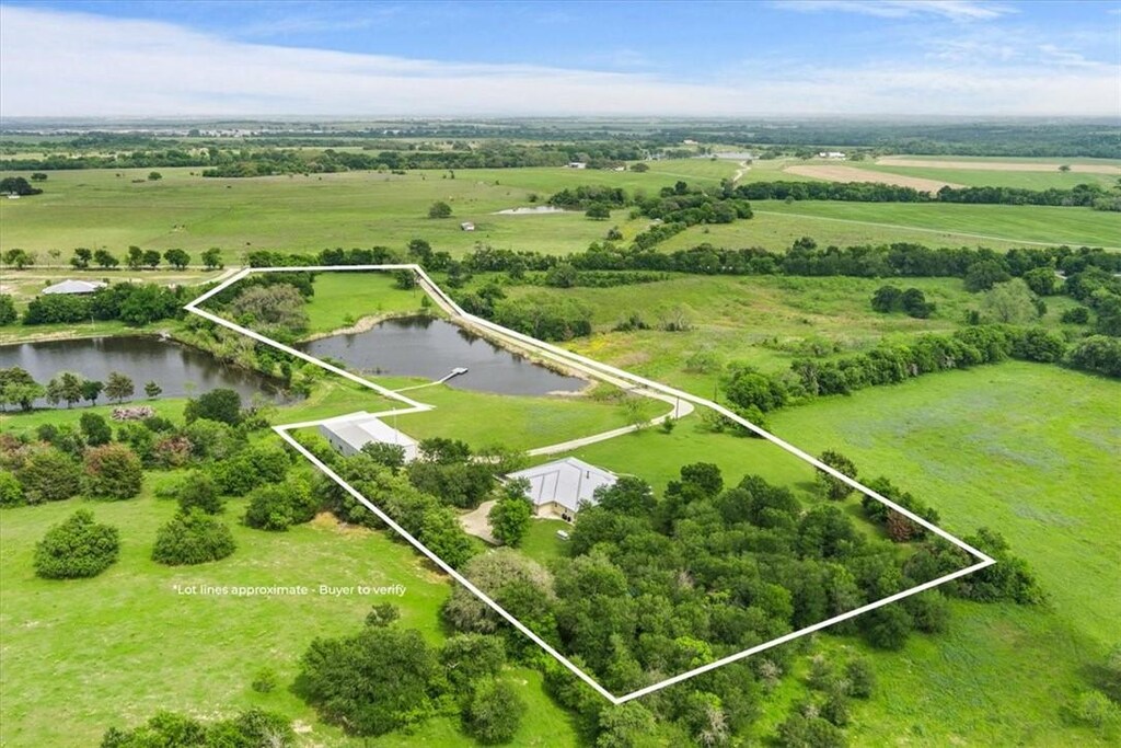 aerial view featuring a rural view and a water view