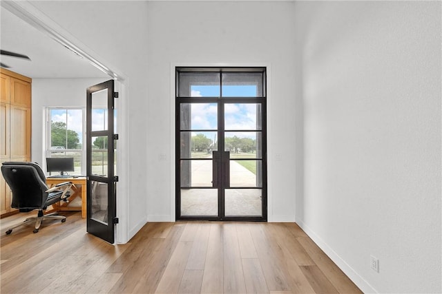 entryway with light wood-type flooring and french doors