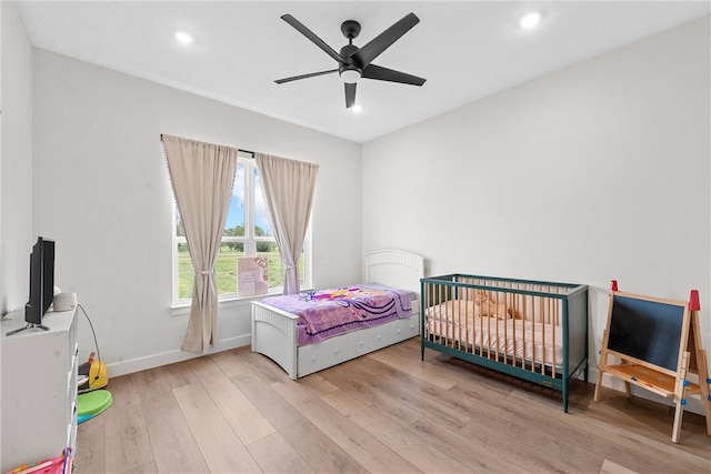 bedroom featuring ceiling fan and light hardwood / wood-style flooring