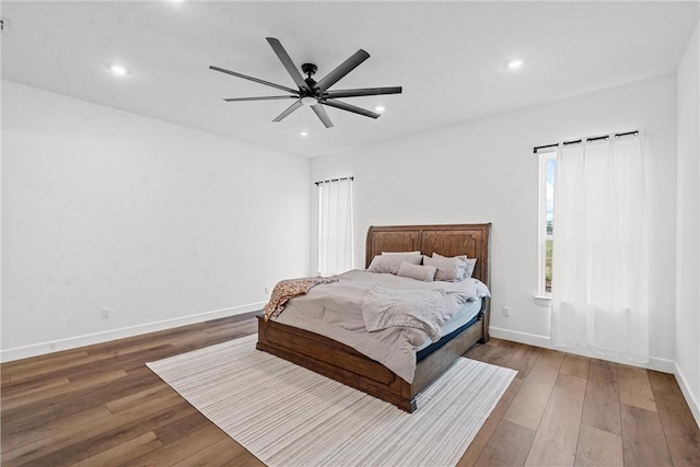 bedroom with ceiling fan and dark wood-type flooring