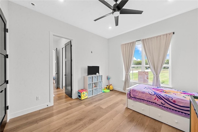 bedroom with ceiling fan and light hardwood / wood-style floors